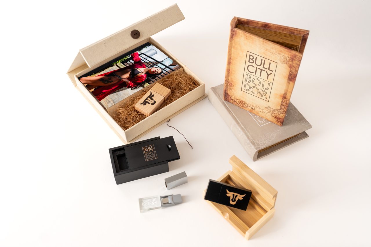 Product photography of Bull City Boudoir swag, albums, and USB drives.